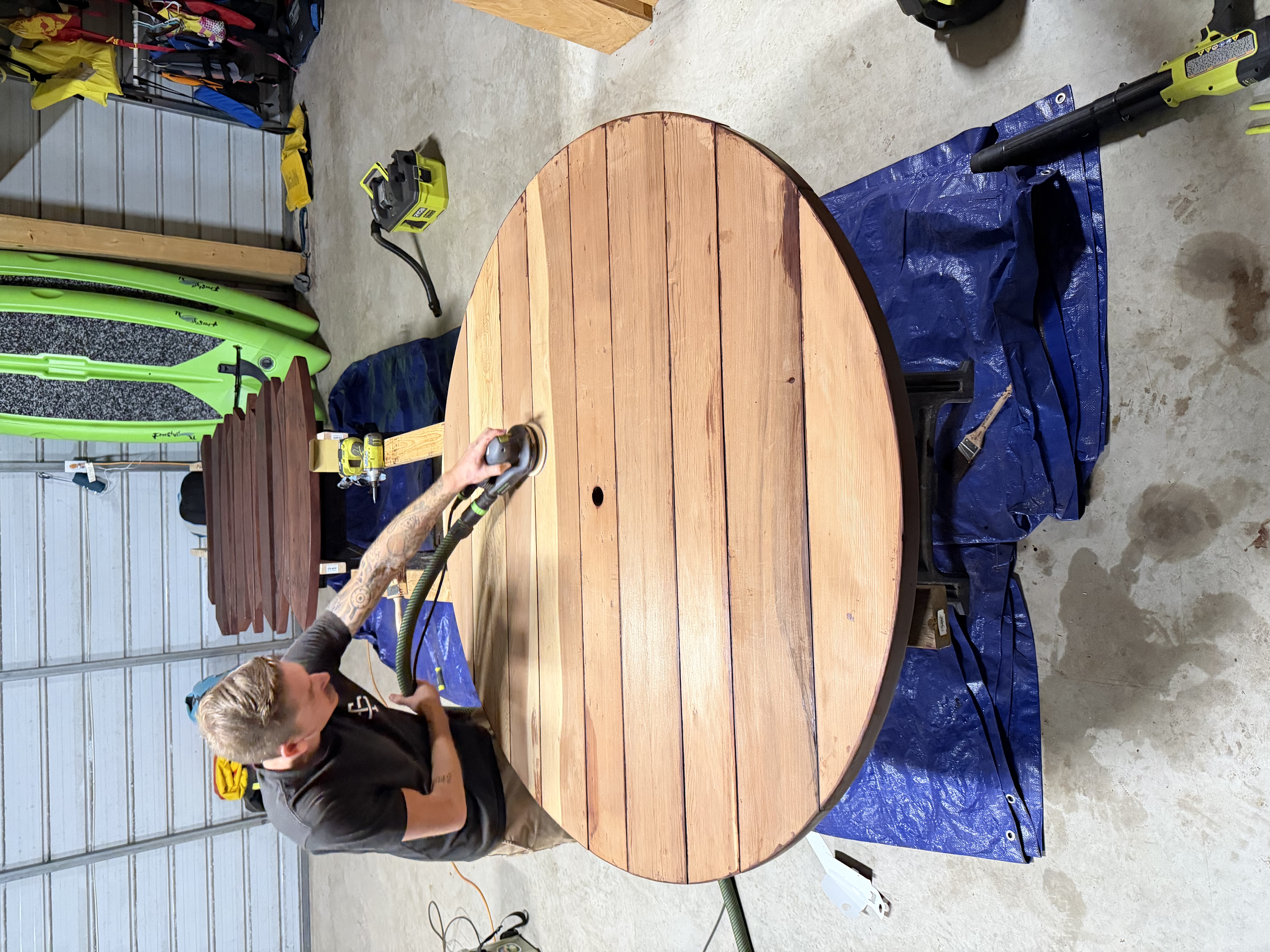 Sanding a handcrafted wood table in the workshop